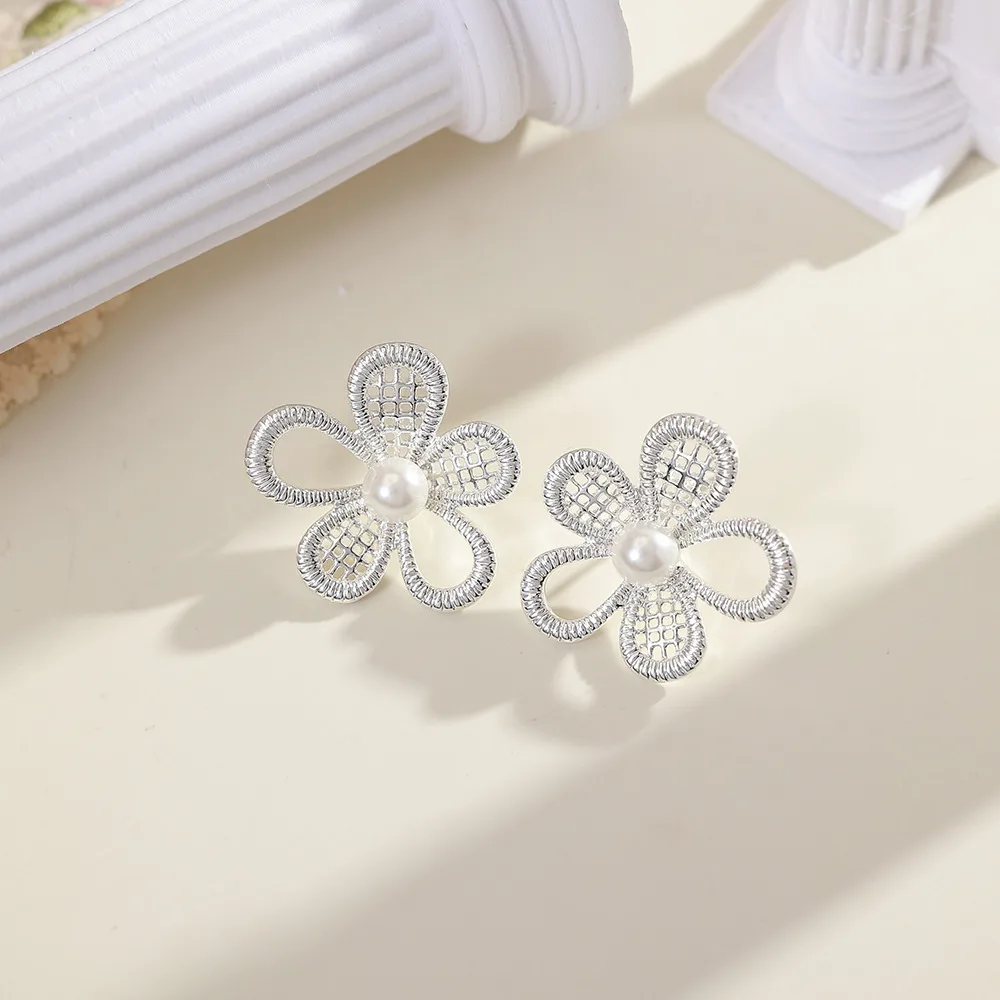 O1CN01l5rmFY2BaeGW9CYss_2214616708355-0-cib Ballet Silver White Hollow Flower Stud Earrings - Image 1